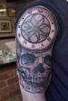 Black and Grey Skull and roman numeral time piece half sleeve.